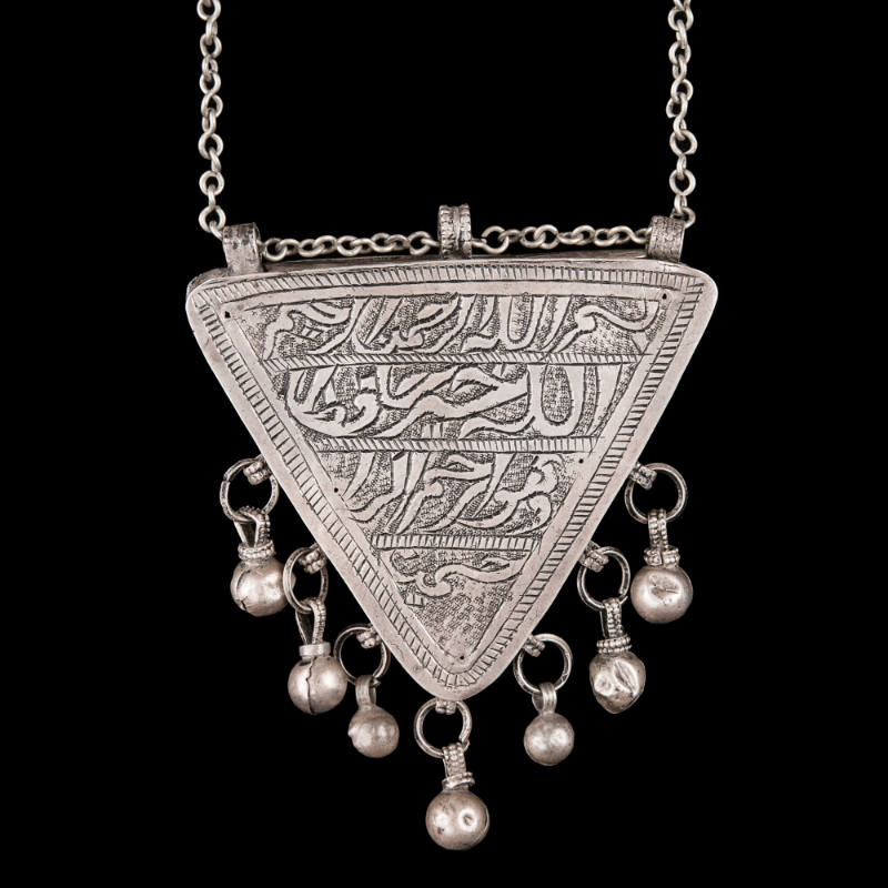 Necklace with triangular amulet container
