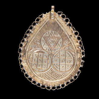 Pendant inscribed with magic squares containing Arabic writing