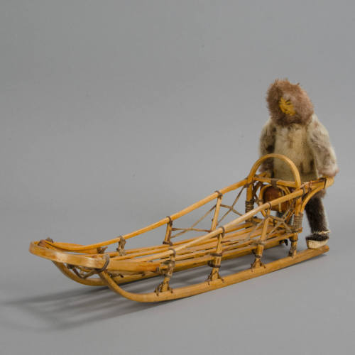 Man and dog sled doll