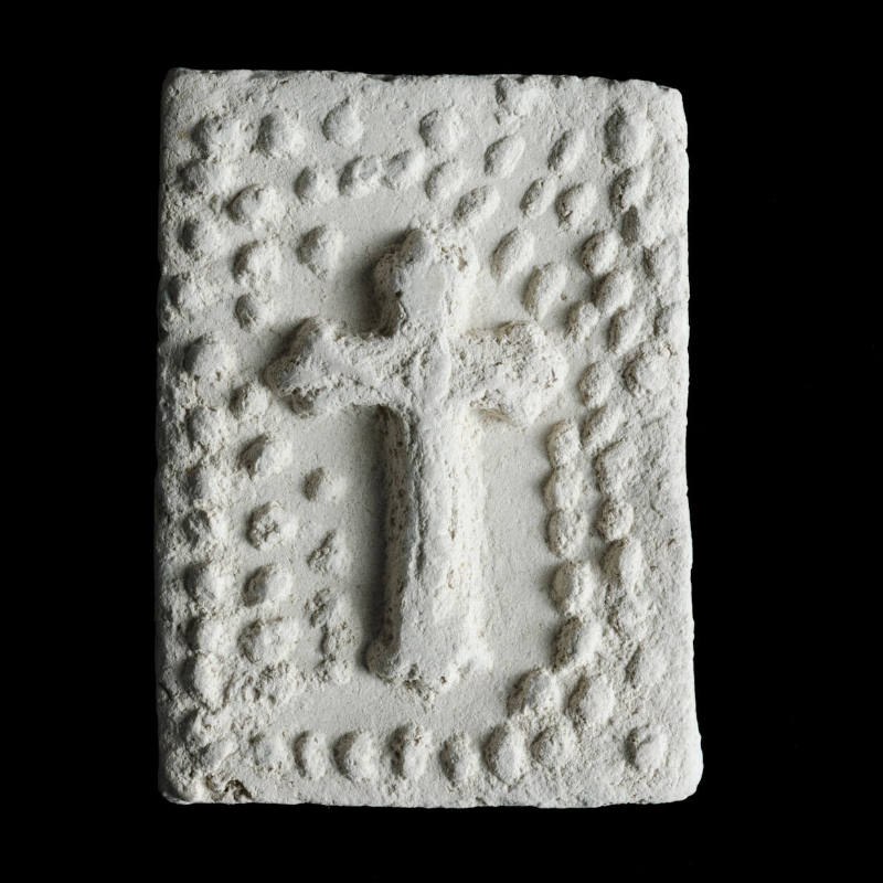 Sacred clay tablet with crucifix under arch of many small flowers