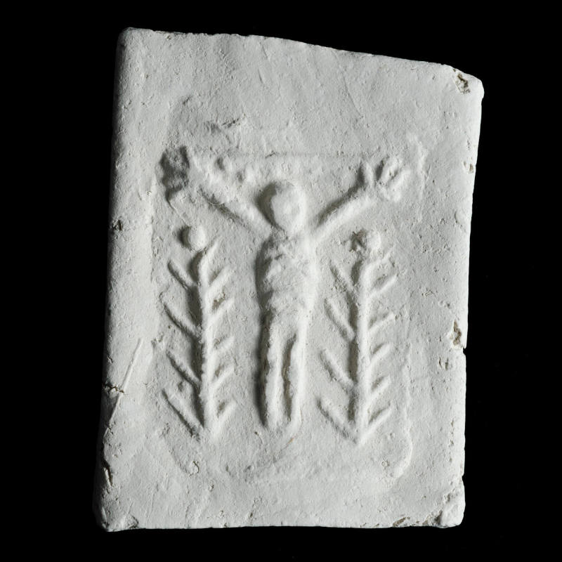 Sacred clay tablet with crucifix in center with tall plants (lilies) flanking base