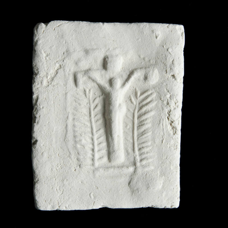 Sacred clay tablet with small crucifix in center