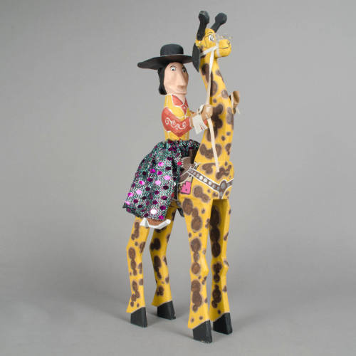 Giraffe and rider figurine