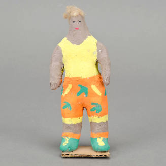 Man in orange print shorts figurine