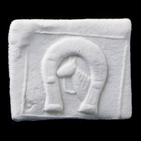 Impressed clay tablet votive offering with horse framed in horseshoe