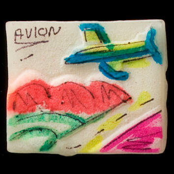 Painted tablet votive offering with airplane over mountains