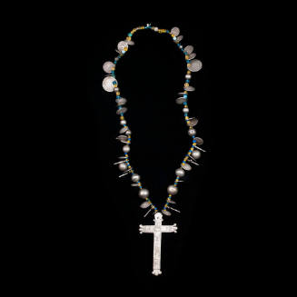Necklace with incised cross, blue and yellow glass beads, and silver beads
