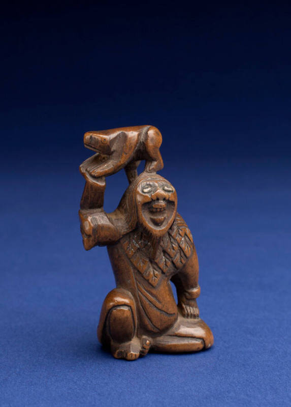 Netsuke in the form of an Ogre holding an Animal