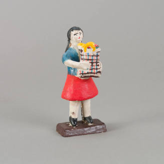 Figure, woman holding bag of groceries