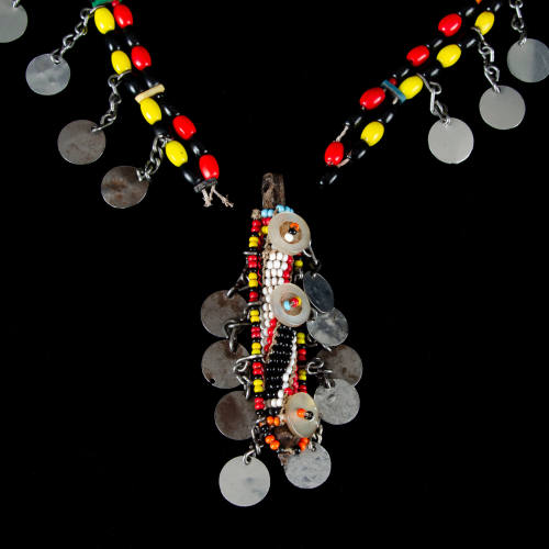 Necklace of beads w/metal dangles and cylindrical pendant
