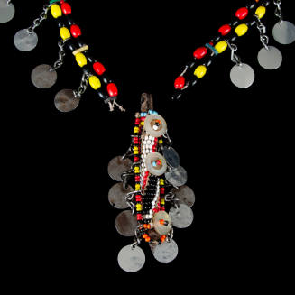 Necklace of beads w/metal dangles and cylindrical pendant