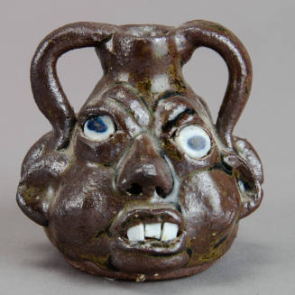 Miniature two-faced face jug