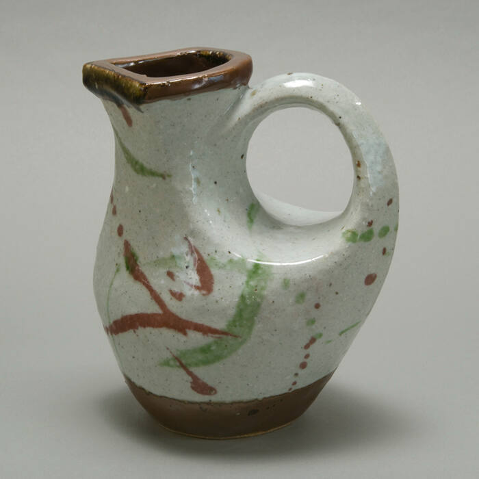 Stoneware Multicolor bird-form water pitcher with box.