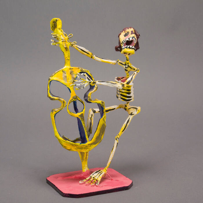 Papier mache skeleton with bass instrument