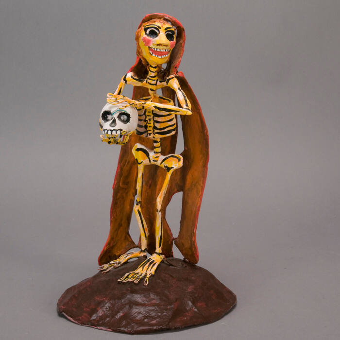 Sculpture, skeleton holding skull