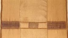 Detail of a raffia palm fiber panel made up of several pieces of diamond and zig-zag patterned …