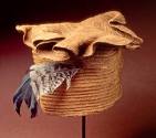 Tikar hat with feather and scalloped brim. Made of natural raffia fiber.  The feather was proba…