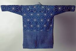 Sashiko stitching in "star" patterns across top-back of indigo colored, cotton coat.  Linear st…