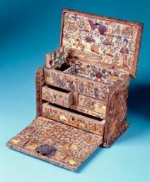 Small antique drop-front cabinet containing drawers; covered in elaborately worked colored stra…