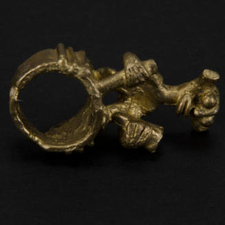 Ring with standing figure