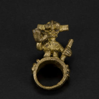 Ring with standing figure