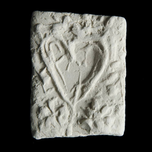 Sacred clay tablet with heart shape in center