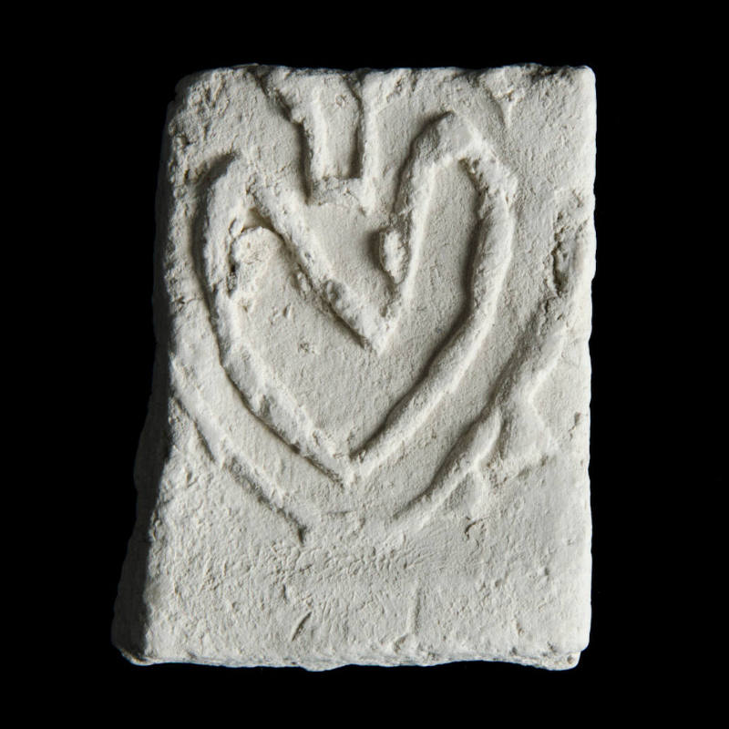 Sacred clay tablet with heart in center 