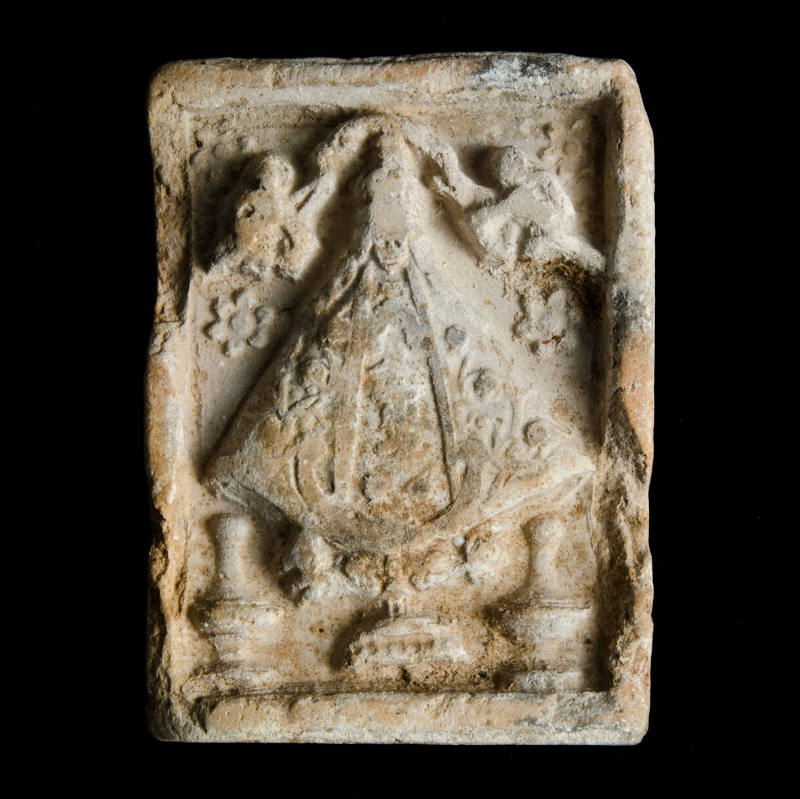 Sacred clay tablet mold of Virgin with six-petaled flowers