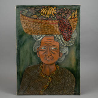 Portrait of a woman carrying a basket of fruit on her head.